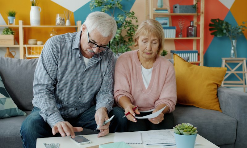 Couple reviewing their pension paperwork at home