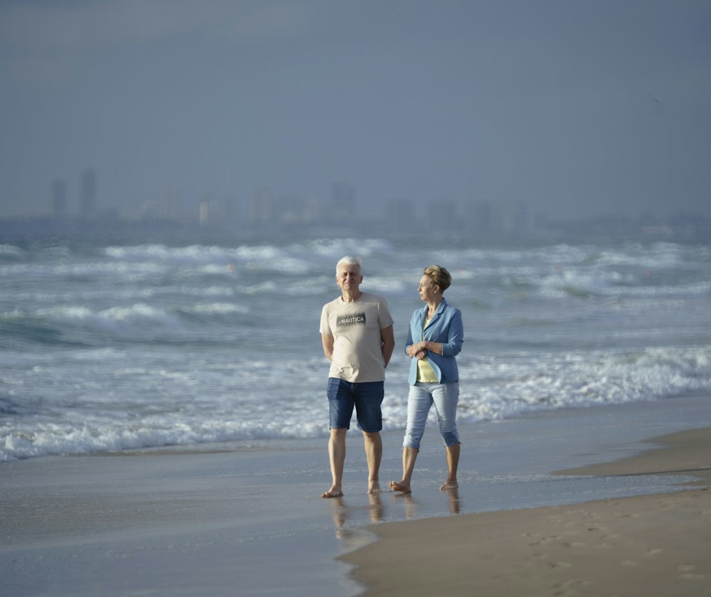 Retired couple walking together along the shoreline